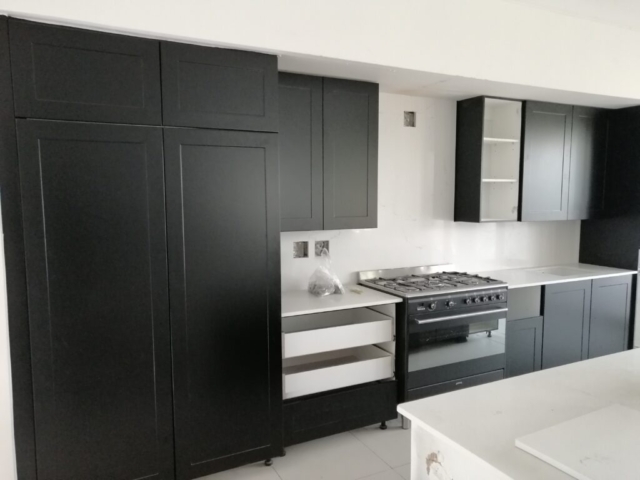 black cabinets with white quartz